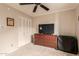 Neat, simple bedroom design with carpet, ceiling fan, and television at 4441 W Windrose Dr, Glendale, AZ 85304
