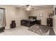 Neutral-toned bedroom with tiled floor, ceiling fan, and decor at 4441 W Windrose Dr, Glendale, AZ 85304