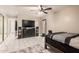 Nicely decorated bedroom with modern entertainment system, tiled floor and ceiling fan at 4441 W Windrose Dr, Glendale, AZ 85304