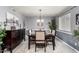 Formal dining room with modern lighting, plush rug, and stylish decor elements at 4441 W Windrose Dr, Glendale, AZ 85304