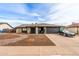 Inviting single-story home with a black two-car garage and modern desert landscaping at 4441 W Windrose Dr, Glendale, AZ 85304