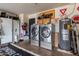 Well-equipped garage with laundry facilities, storage, and various tools and equipment for home maintenance at 4441 W Windrose Dr, Glendale, AZ 85304
