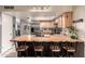 Open-concept kitchen with breakfast bar, stainless steel appliances, and island sink at 4441 W Windrose Dr, Glendale, AZ 85304