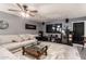 Comfortable living area with a large TV, cozy seating, and a stylish glass-topped coffee table on a soft rug at 4441 W Windrose Dr, Glendale, AZ 85304