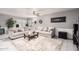 Bright living room with a cozy sectional sofa, decorative pillows, and a glass-topped coffee table on a plush rug at 4441 W Windrose Dr, Glendale, AZ 85304