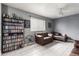 Cozy living room with leather seating, built-in shelving, and neutral tile flooring at 4441 W Windrose Dr, Glendale, AZ 85304