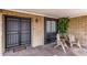 Cozy front porch with seating, a secured front door, and brick walls at 4441 W Windrose Dr, Glendale, AZ 85304