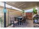 Cozy covered patio area with a dining table, chairs, and access to the pool, perfect for outdoor entertaining at 4441 W Windrose Dr, Glendale, AZ 85304