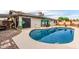 Beautiful backyard featuring a pool with solar panels, stone accents, and a covered seating area for outdoor enjoyment at 4441 W Windrose Dr, Glendale, AZ 85304