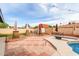 Backyard pool area with patio, diving board, and decorative umbrella stands at 4441 W Windrose Dr, Glendale, AZ 85304