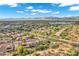 Expansive aerial shot showcases a vast community of homes with mountain views, neighborhood streets, and desert landscaping at 4449 E Rancho Caliente Dr, Cave Creek, AZ 85331
