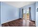 Blue bedroom features wood floors, sliding glass door to the patio, and modern ceiling at 4449 E Rancho Caliente Dr, Cave Creek, AZ 85331