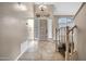 Inviting entryway features tile flooring, a wooden front door, and a staircase at 4449 E Rancho Caliente Dr, Cave Creek, AZ 85331