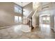 Welcoming entryway boasts tile floors, a staircase, soaring ceilings, and natural light at 4449 E Rancho Caliente Dr, Cave Creek, AZ 85331