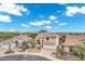A two-story home boasts desert landscaping, a tile roof, and an attached two-car garage in a planned community at 4449 E Rancho Caliente Dr, Cave Creek, AZ 85331