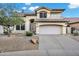 Inviting home featuring a neutral color palette, two-car garage, and well-maintained desert landscaping at 4449 E Rancho Caliente Dr, Cave Creek, AZ 85331