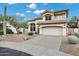 Beautiful two-story home featuring stucco siding, a tile roof, three-car garage and desert landscaping at 4449 E Rancho Caliente Dr, Cave Creek, AZ 85331
