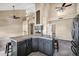 Open-concept kitchen with island and breakfast bar overlooking spacious great room with fireplace at 4449 E Rancho Caliente Dr, Cave Creek, AZ 85331