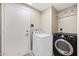 Laundry room with washer, dryer, white door, and neutral walls at 4449 E Rancho Caliente Dr, Cave Creek, AZ 85331