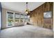 Bright living room with a wood accent wall, carpet flooring and backyard access at 4449 E Rancho Caliente Dr, Cave Creek, AZ 85331