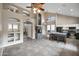 Spacious living room with a stone fireplace, tile floors, and a kitchen island with bar seating at 4449 E Rancho Caliente Dr, Cave Creek, AZ 85331