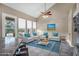 Bright living room with high ceilings, a ceiling fan, large windows and a stylish blue rug at 4449 E Rancho Caliente Dr, Cave Creek, AZ 85331