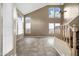 Bright living room features tile flooring, a staircase, and high windows with backyard views at 4449 E Rancho Caliente Dr, Cave Creek, AZ 85331