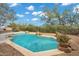 Sparkling backyard pool surrounded by rock accents, desert landscaping, and privacy fencing at 4449 E Rancho Caliente Dr, Cave Creek, AZ 85331