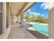 A covered patio offers views of the pristine pool, featuring natural rock accents and serene backyard landscaping at 4449 E Rancho Caliente Dr, Cave Creek, AZ 85331