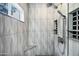 Modern walk-in shower with gray geometric tile, rainfall shower head, and built-in bench at 4449 E Rancho Caliente Dr, Cave Creek, AZ 85331