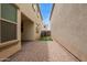 Narrow backyard with artificial turf and brick pavers between homes at 4853 S Charger --, Mesa, AZ 85212