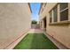 Narrow backyard with artificial turf and brick pavers between homes at 4853 S Charger --, Mesa, AZ 85212