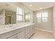 Bright bathroom featuring a double sink vanity, large mirrors, and natural light from two windows at 4853 S Charger --, Mesa, AZ 85212