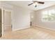 This bedroom features carpeted floors, a ceiling fan, and natural light from a window at 4853 S Charger --, Mesa, AZ 85212