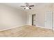 A neutral bedroom features carpeted floors, a fan, and a closet with sliding doors at 4853 S Charger --, Mesa, AZ 85212