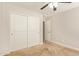 Carpeted bedroom featuring double sliding door closet with overhead ceiling fan at 4853 S Charger --, Mesa, AZ 85212