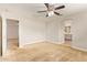 Bright, carpeted bedroom with a ceiling fan and open access to the bathroom and another room at 4853 S Charger --, Mesa, AZ 85212