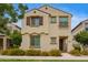 Charming two-story home featuring a decorative wrought iron balcony and colorful yellow flowering bushes at 4853 S Charger --, Mesa, AZ 85212