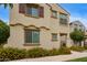 Charming two-story home featuring a decorative wrought iron balcony and colorful yellow flowering bushes at 4853 S Charger --, Mesa, AZ 85212
