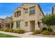 Charming two-story home featuring a decorative wrought iron balcony and colorful yellow flowering bushes at 4853 S Charger --, Mesa, AZ 85212
