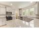 Modern kitchen with granite countertops, stainless steel appliances, and light grey cabinetry at 4853 S Charger --, Mesa, AZ 85212