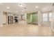 Open-concept living room with tile flooring, sliding glass doors to the patio, and a breakfast bar to the kitchen at 4853 S Charger --, Mesa, AZ 85212