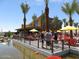 Community park featuring outdoor seating, palm trees, and umbrellas near a waterfront area at 4853 S Charger --, Mesa, AZ 85212