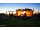 Outdoor stage setup for concert with people gathered on the lawn at dusk at 4853 S Charger --, Mesa, AZ 85212