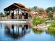 Community park featuring a covered pavilion reflected in a pond and an orange play structure at 4853 S Charger --, Mesa, AZ 85212