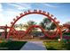 Community playground featuring the bright orange 'Orange Monster' climbing structure at 4853 S Charger --, Mesa, AZ 85212
