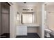Bathroom showcasing a vanity with a sink and mirror with open closet to the side at 5104 W Fulton St, Phoenix, AZ 85043