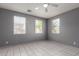 Bright bedroom featuring tile flooring, neutral paint, and well-lit windows at 5104 W Fulton St, Phoenix, AZ 85043
