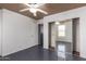 A bright bedroom with gray tile floors features a ceiling fan and closet with mirrored sliding doors at 5104 W Fulton St, Phoenix, AZ 85043