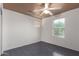 The bedroom features gray tile flooring, a ceiling fan, and natural light from the window at 5104 W Fulton St, Phoenix, AZ 85043